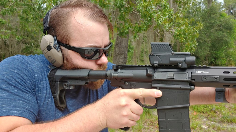 profile of travis pike with hearing protection aiming Springfield Armory Saint Victor AR-10 pistol