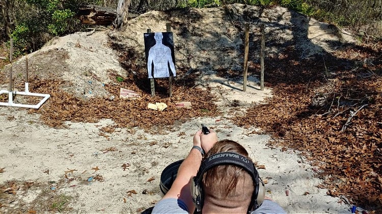 Altor pistol aimed at target at 5-yard range.