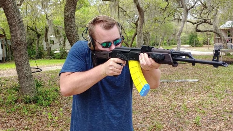 Travis Pike aiming AK with US Palm yellow AK30 magazine.