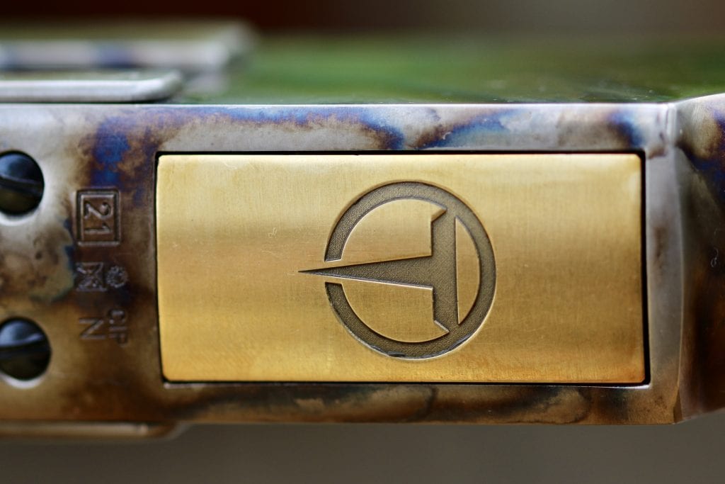 Taylor's logo plate on rifle