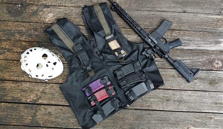 Heat replica vest from forgotton weapons, loaded with magazines, next to a Hockey mask