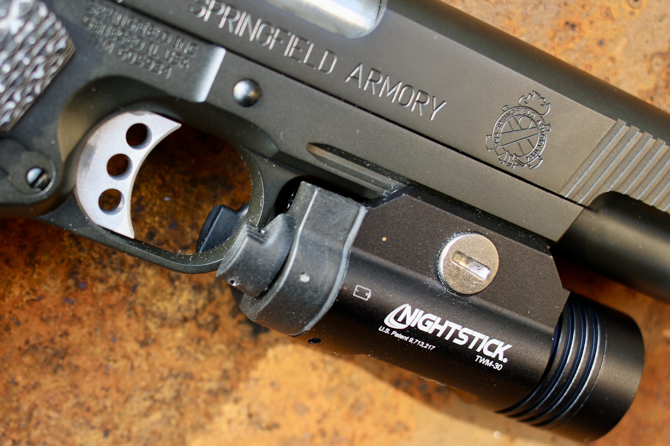 The Nightstick, on the Springfield Armory TRP, fits perfectly. Note how the buttons extend beyond the trigger guard.