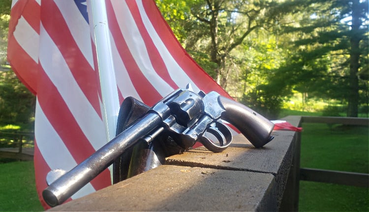 Colt New Army Model 1901 revolver in front of American Flag.