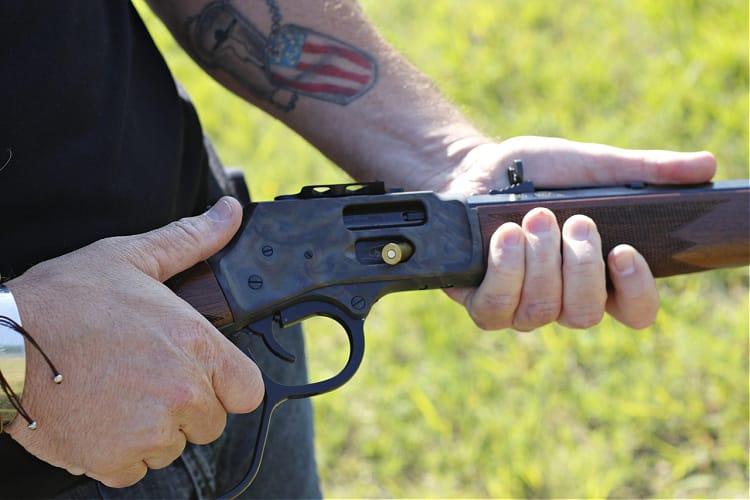 load side gate lever gun by leaving one round partially out, then use the nose of the next round to push it in.