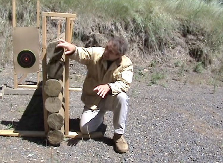 Paul Harrel stacking six inch poles to simulate a log cabin wall for his AK-47 vs M16 test