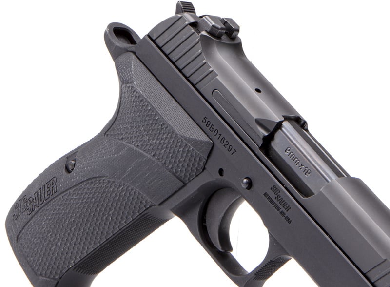 The P210 Carry has a lightweight alloy frame and checkered G10 grips.