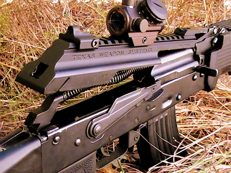 An American made enhanced dust cover that attaches to the receiver and hinges up. This one is installed on an Israeli Galil, which is based on the AKM.