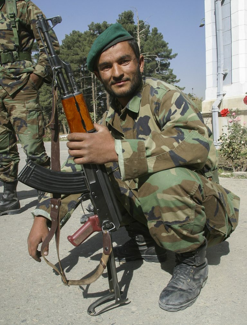 Afghan soldier with AK that has under-folding stock and skinny pistol grip