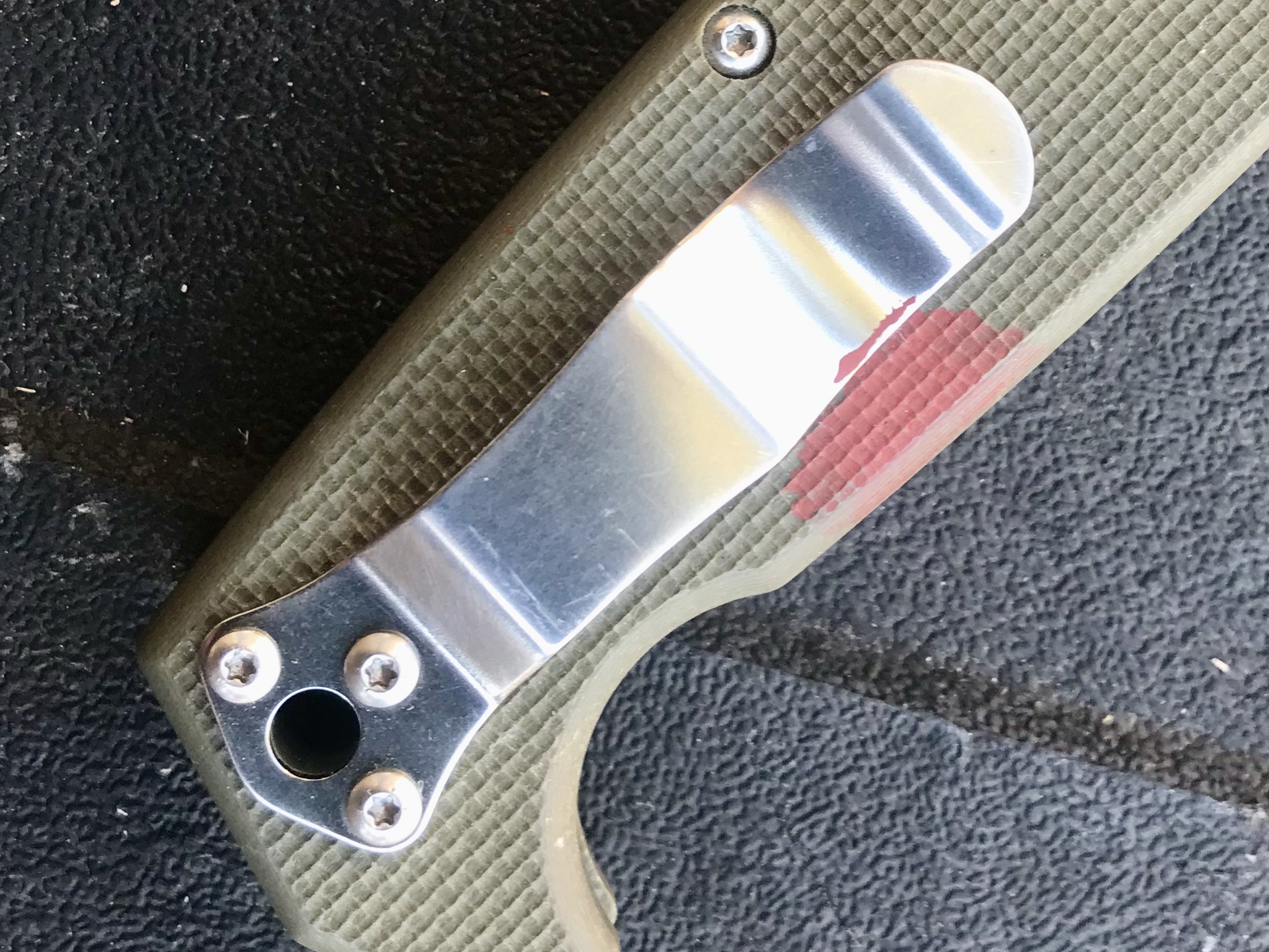 I spilled some paint on the grip. I may have been opening the can with the edge of a scale. But the clip--that's the point here--is wide and robust enough for the knife's weight.