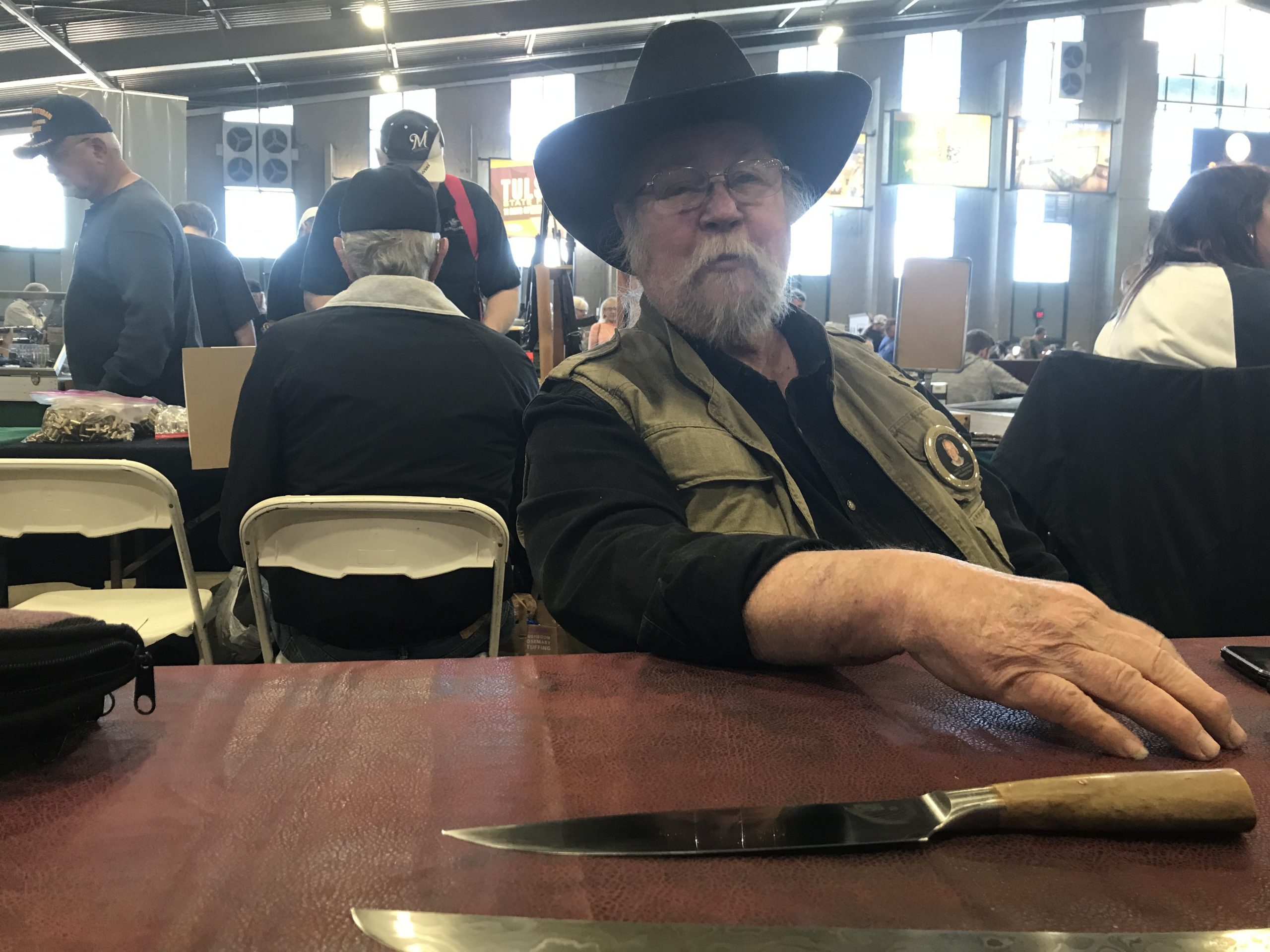 An oddity--one old bladesmith, the Myers behind Myers Knives, sitting at a lonely table with a couple of really nice blades.