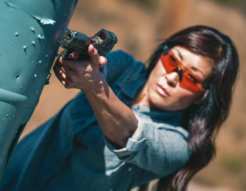 Woman shooting a Walther PDP F-series handgun.