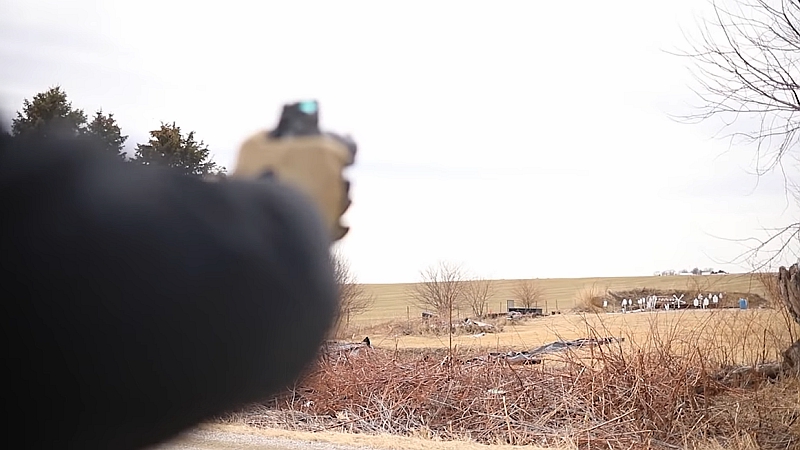 Aiming handgun at 130 yards