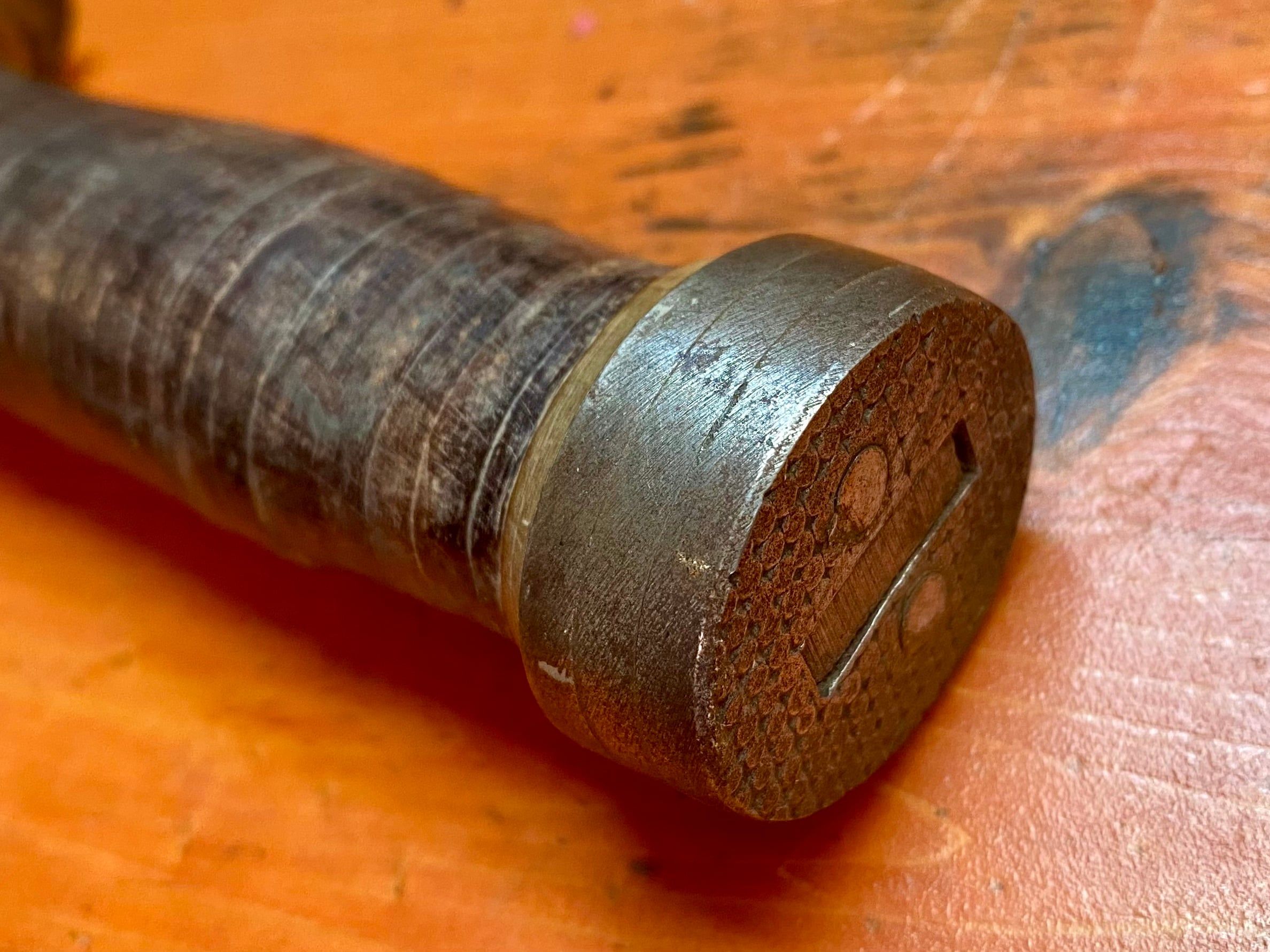 Note the three-piece pommel. The steel stacks and spins to lock in place before being nailed down.