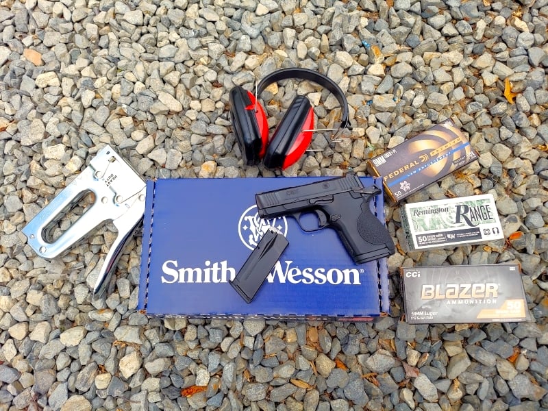 Smith & Wesson CSX with range gear and boxes of ammunition