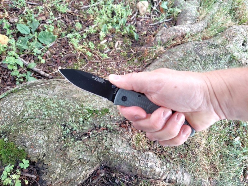 Kabar Dozier folding knife in hand, on the list of budget-friendly quality knives