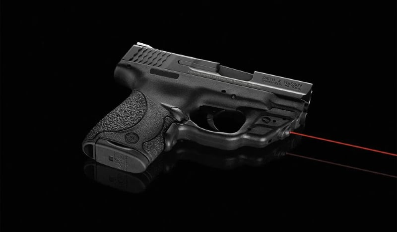 Smith & Wesson pistol with Crimson Trace laser mounted to trigger guard