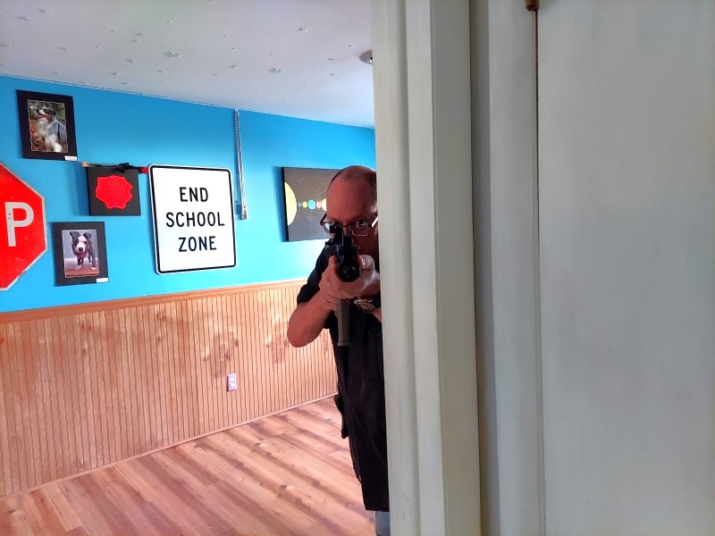 Author with AR pistol in a house.