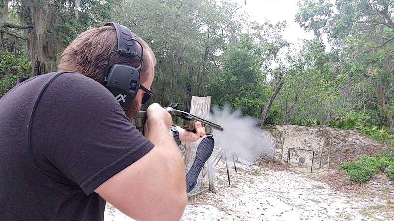 Travis Pike aims Mossberg 940 Pro Turkey shotgun at steel target