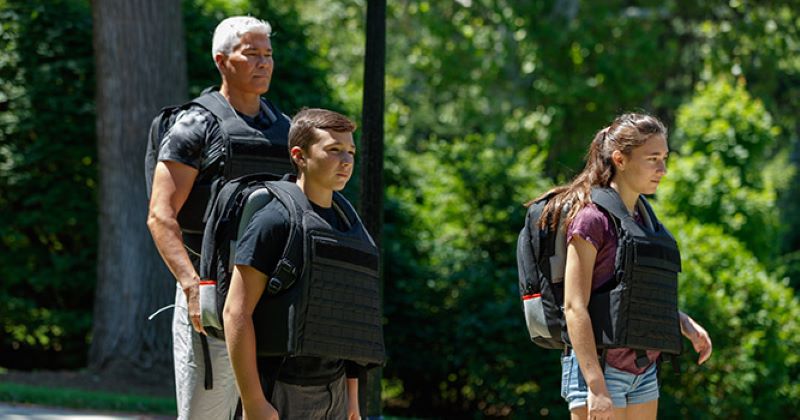 family wearing quick deployment body armor backpacks