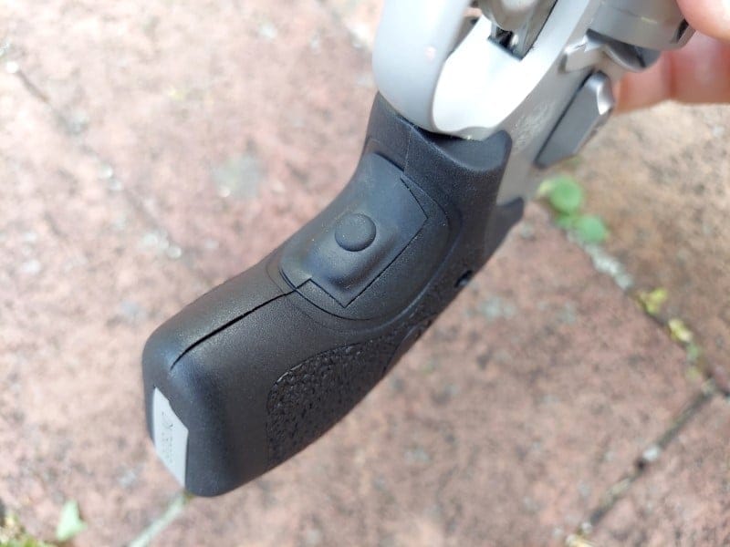 Activation button on the front of the Crimson Trace grip.
