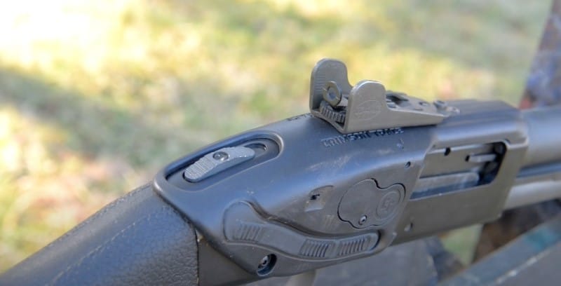 Crimson Trace LS-250 mounted on shotgun, closeup of tang safety.