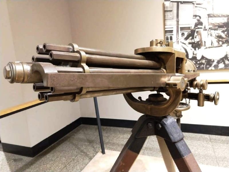 A Colt 1874 Gatling Gun mounted on a tripod.