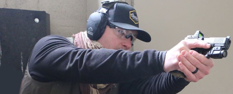 Main aims pistol with red dot sight at indoor range at Gunsite Academy