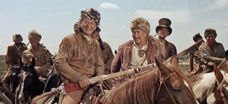 John Wayne as Davy Crockett with his 36 caliber Kentucky Rifle, wrapped in deer hide. 