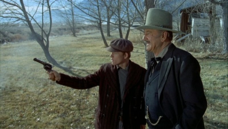 In The Shootist, John Wayne portrays an elderly gunfighter dying of cancer. Here he shows Gilliam how to shoot his revolver.