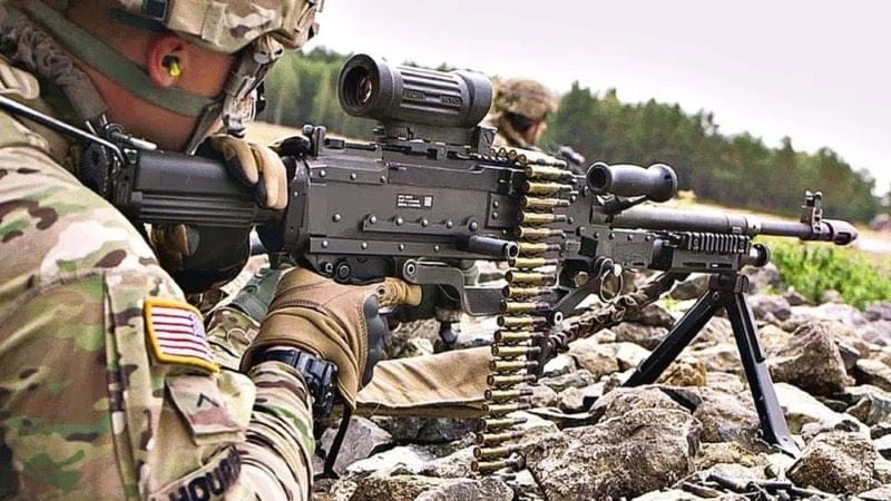 A 240 gunner takes aim with an optically sighted M240.