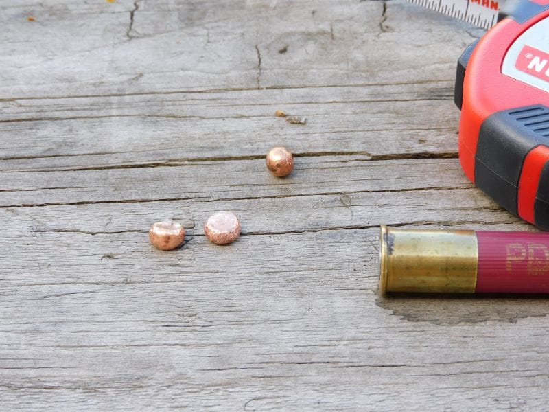 Three recovered copper plated projectiles on a table.