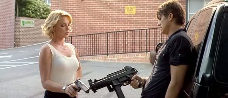 Kutcher and Heigl in the aftermath of a firefight with their guns.
