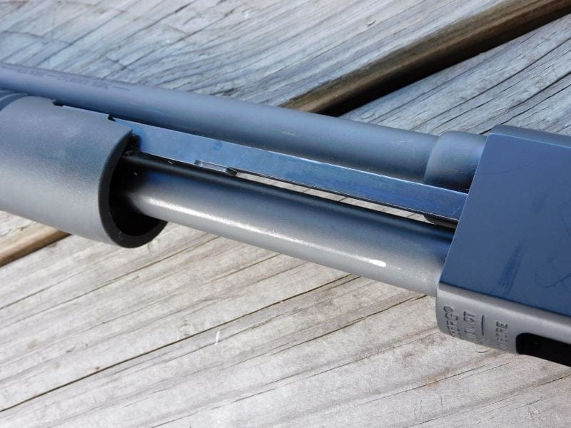 The pump action, barrel, and magazine tube of the Mossberg 590.
