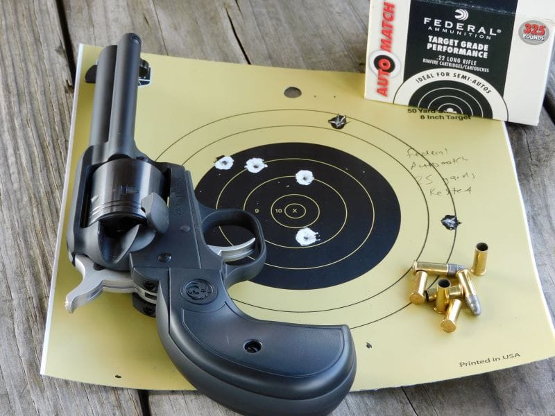 The Wrangler and a box of ammunition resting on a used paper target.