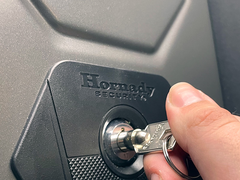 Key being turned by hand for Hornady's Alpha Elite safe.