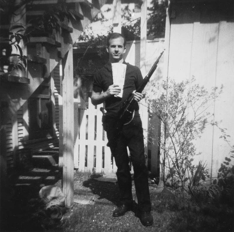 Lee Harvey Oswald holding the rifle