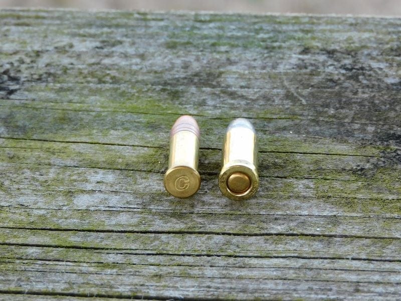 25 ACP round next to a .22LR round