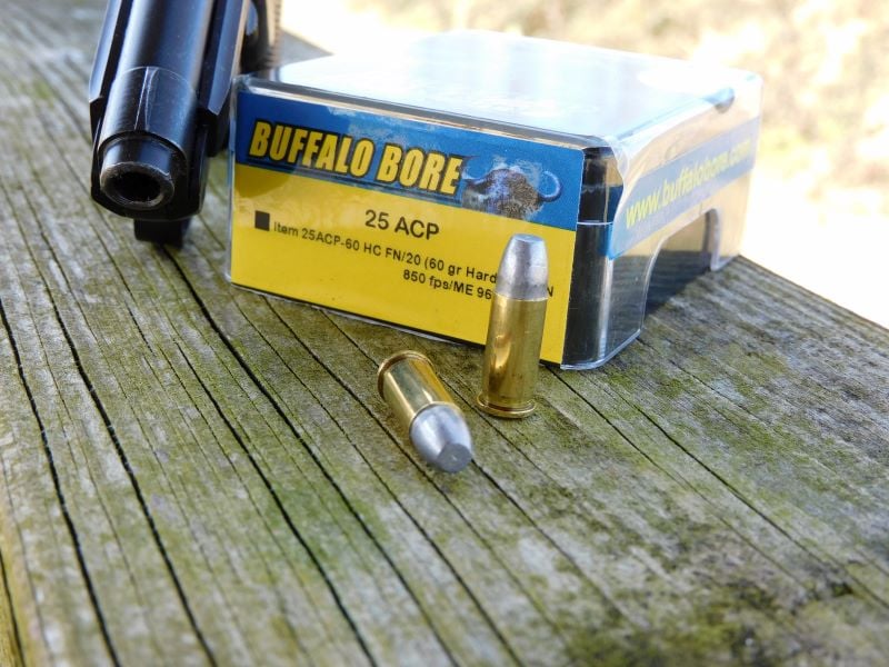 A box of Buffalo Bore ammunition with two rounds displayed.