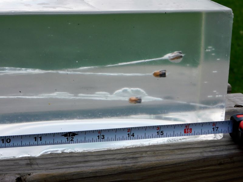 A closeup of projectiles inside the second gel block with a tape measure for reference.