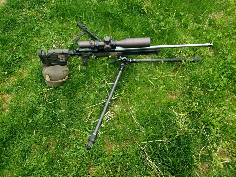 a rifle clipped into a tripod in the low position