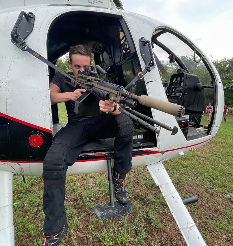 Jack Copeland in helicopter with an M249 Saw