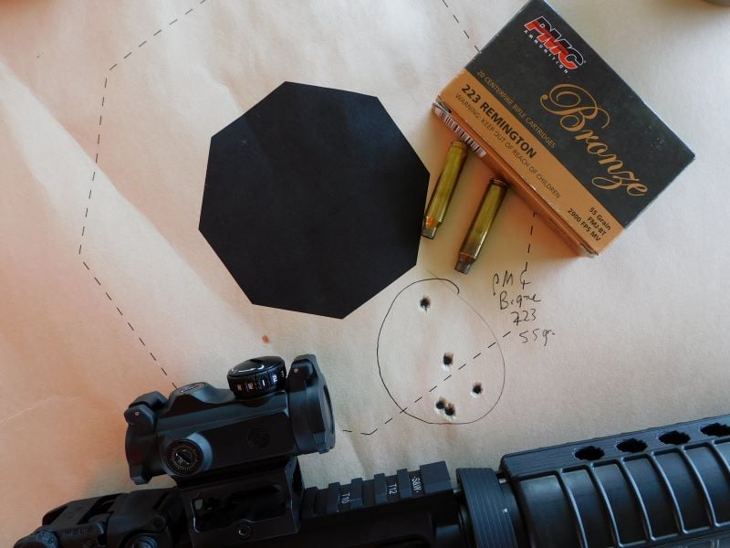 Sig Romeo MSR, box of ammunition, and paper target.