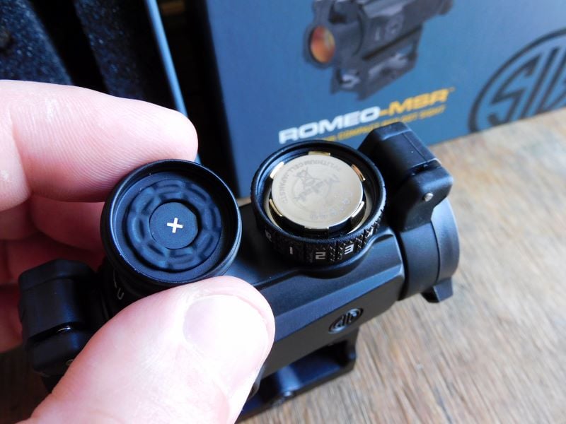 The Sig Romeo MSR adjustment knob taken off to show the battery.