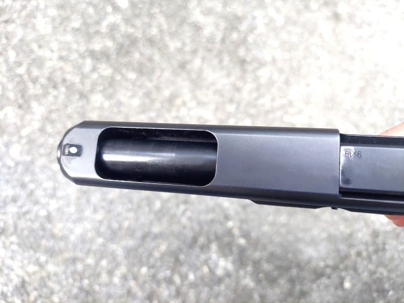 The cutout in the top of the Glock 34's barrel.
