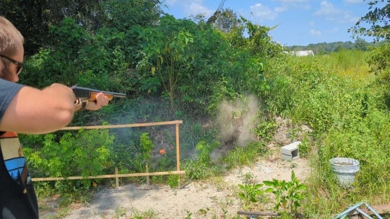 shooting at clay pigeon with shotgun