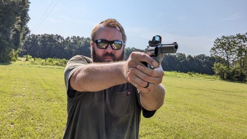 man shooting revolver