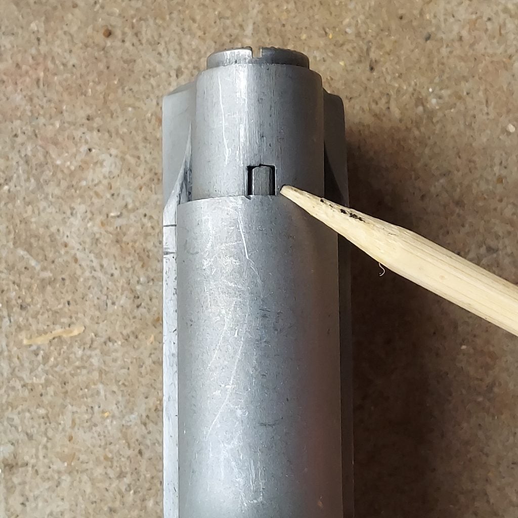 A small tab holds the Officer's ACP recoil spring plug in place.