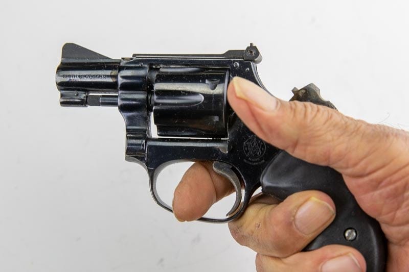 S&W 22 in hand with hammer cocked