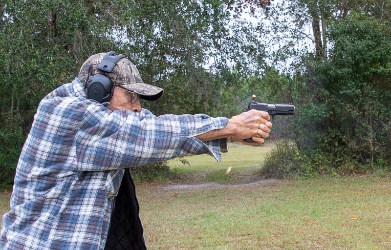 Mas shooting SFT9 with brass in the air