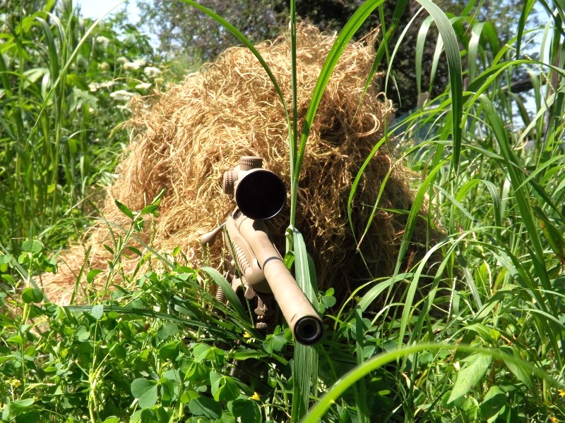 A sniper in ghillie suit.